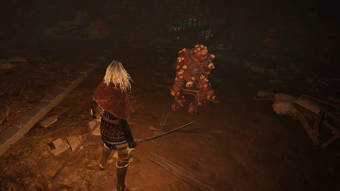 The player in Elden Ring stands before the Dung Eater, chained in a cellar beneath the Capital, Leyndell.