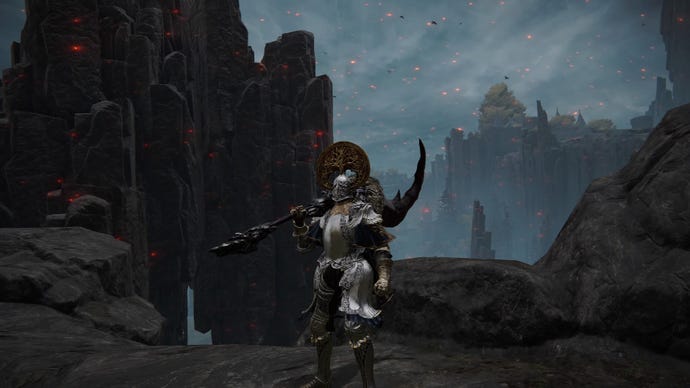 Elden Ring screenshot of the Tarnished atop a cliff, wielding the Fallingstar Beast Jaw Colossal Weapon.