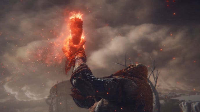 A screenshot from a cutscene in Elden Ring: the Fire Giant raises its own flaming severed leg with a roar.