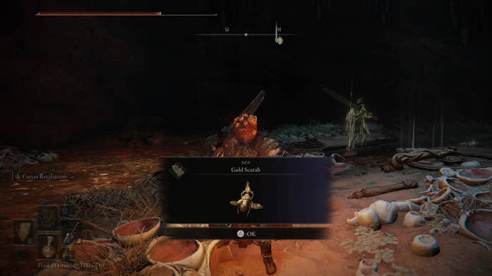 A warrior obtains the Gold Scarab talisman in Elden Ring.