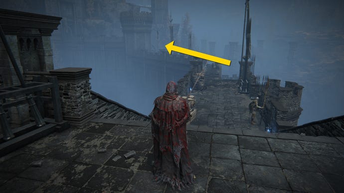 The player in Elden Ring: Shadow Of The Erdtree walks along the ramparts of Castle Ensis. A yellow arrow marks the path towards an Imbued Sword Key.