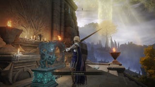 A warrior approaches an imp-like statue in Elden Ring