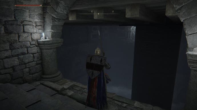 A warrior stands in front of a trap floor in the Impaler's Catacombs in Elden Ring