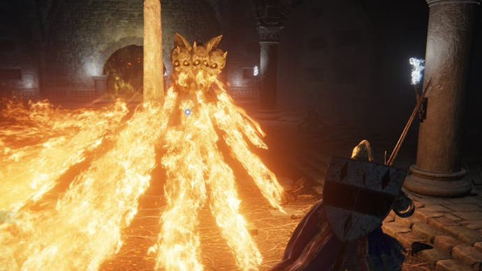A close-up shot of a fire-breathing dog boss attacking the player in the Impaler's Catacombs in Elden Ring.