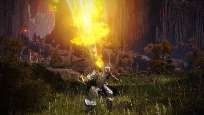 Elden Ring screenshot of the Tarnished atop a cliff, performing the Frenzied Burst Incantation.