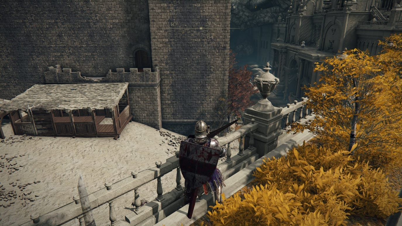 A warrior stands behind some railing in Leyndell Royal Capital in Elden Ring.
