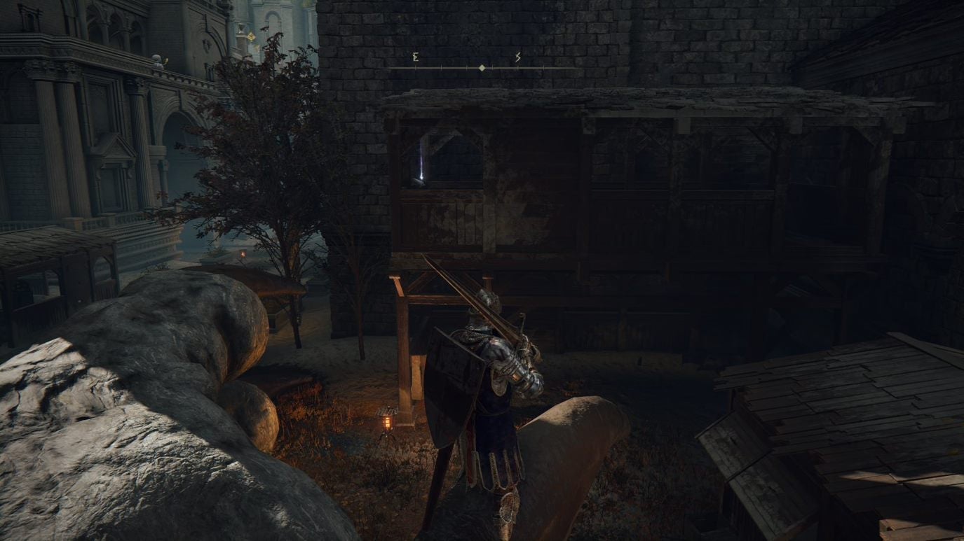 A warrior looks up at a ledge with a Stonesword Key on it in Leyndell Royal Capital in Elden Ring.