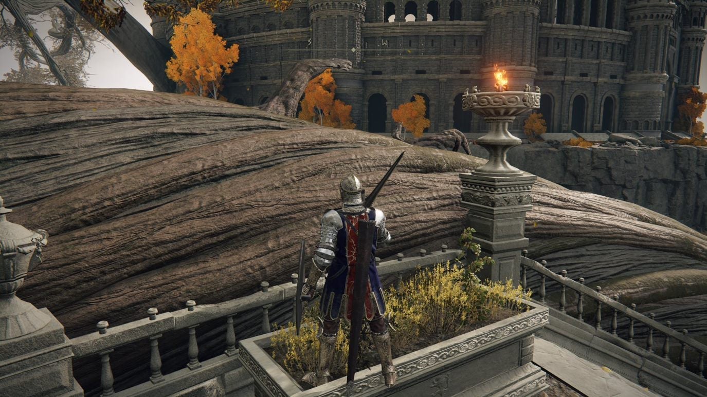 A warrior stands in front of a large tree root in Leyndell Royal Capital in Elden Ring.