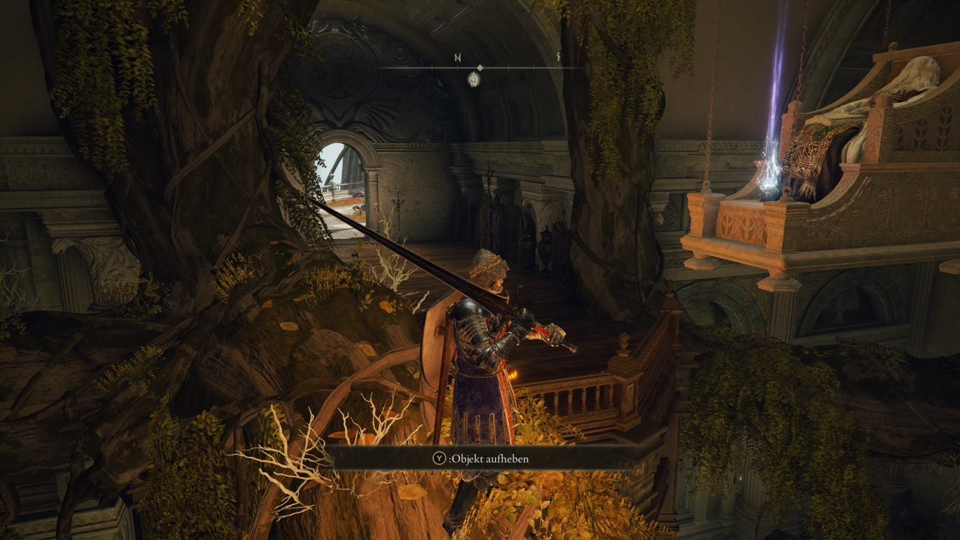 A warrior obtains some Celestial Dew from a statue standing on a tree root in Leyndell Royal Capital in Elden Ring.