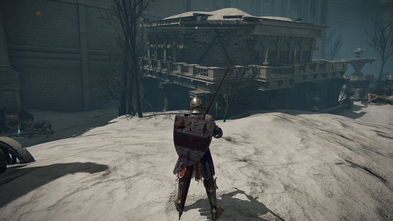 A warrior walks over a sandy area toward an ornate building in Leyndell, Royal Capital in Elden Ring.