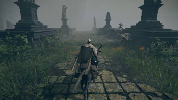 The player in Elden Ring approaches a bridge where a Finger Reader Crone sits on the right-hand side.