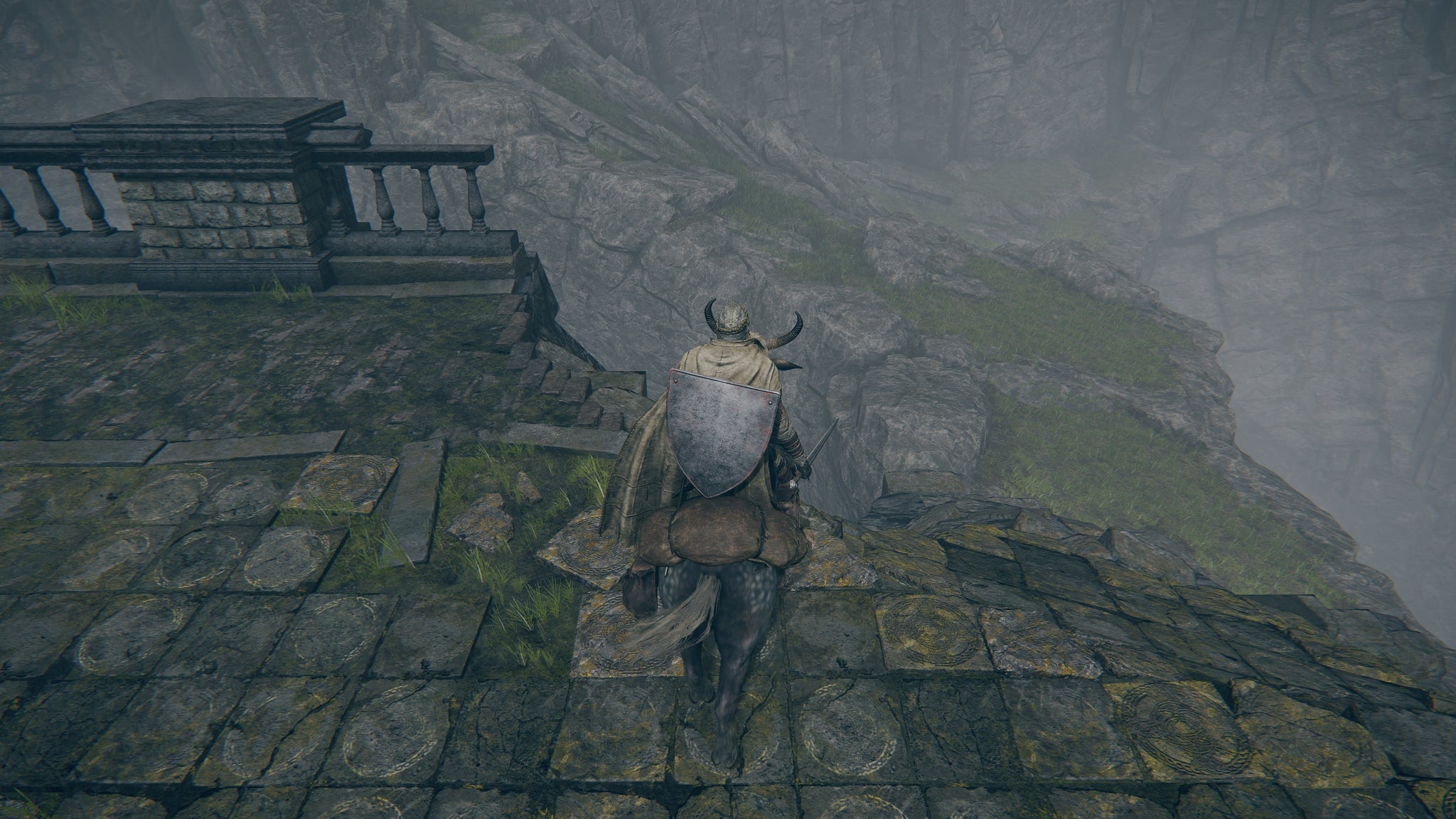 The player in Elden Ring looks down from the end of a broken bridge to a pathway below while on horseback. - 5
