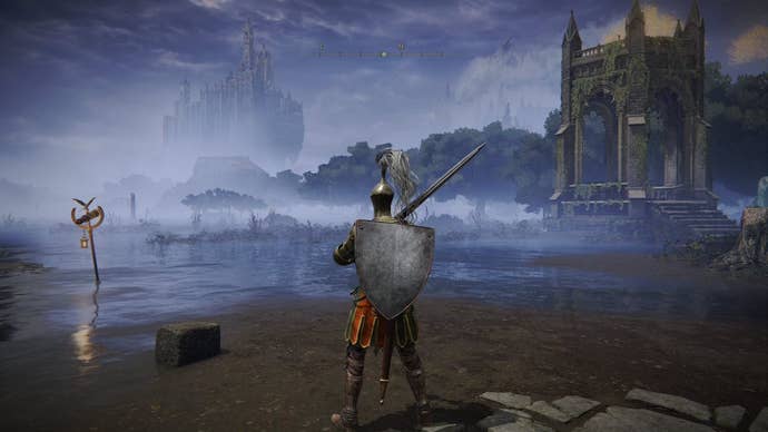 A warrior stands on a patch of dirt in a large lake in Elden Ring’s Liurnia region, with the Raya Lucaria Academy visible in the background.