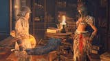 A warrior talks with a female NPC in a library lit by candlelight in Elden Ring