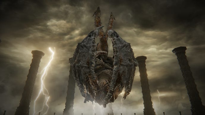 Dragonlord Placidusax from Elden Ring hovers upside down in his arena in Crumbling Farum Azula while lightning strikes in the background.