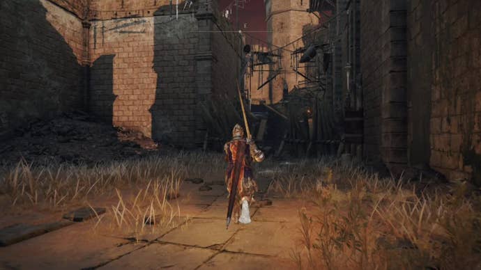 elden ring player holding sword following path in redmane castle