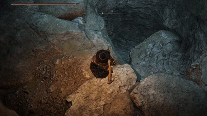 elden ring player looking down hole in seethewater cave