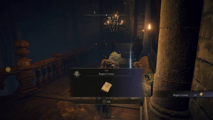 The player takes a letter from Rogier’s corpse in Elden Ring.