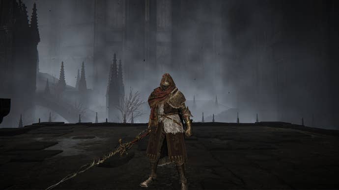 Elden Ring: Shadow Of The Erdtree screenshot of the Tarnished outside the Church District and wielding Fire Knight Queelign’s Greatsword.