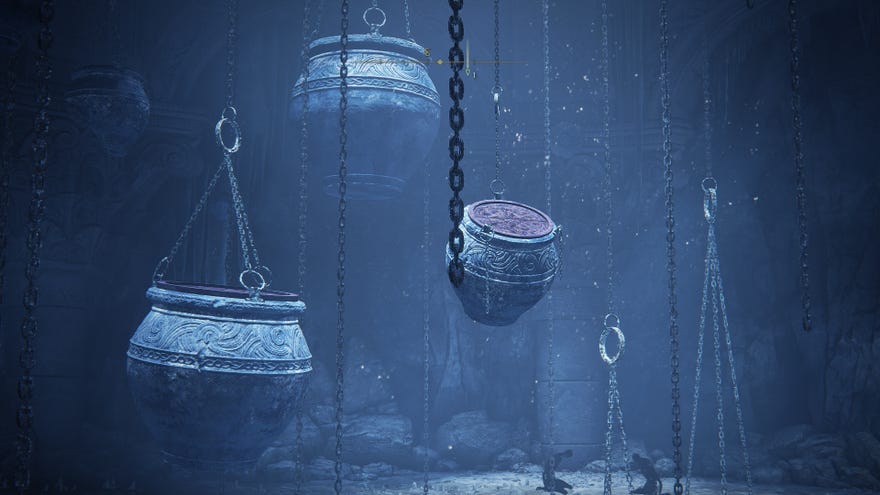 Elden Ring: Shadow Of The Erdtree screenshot of large jars chained to a dungeon ceiling.