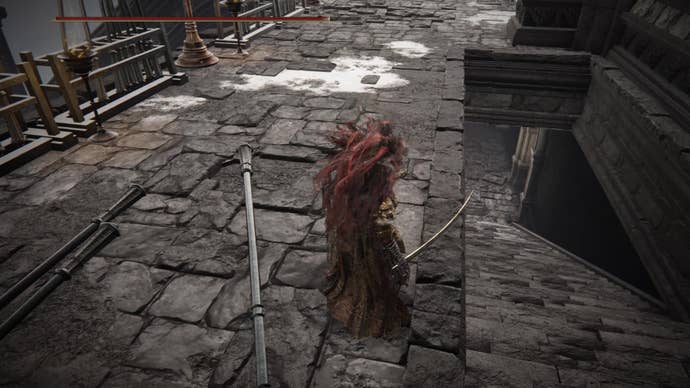 A warrior stands on a stone pathway, looking down at a staircase to a lower level in Elden Ring Shadow of the Erdtree.