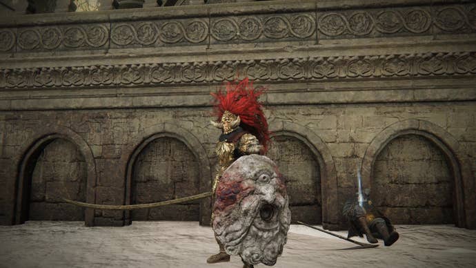 A warrior stands next to Ansbach’s body in Elden Ring Shadow of the Erdtree.