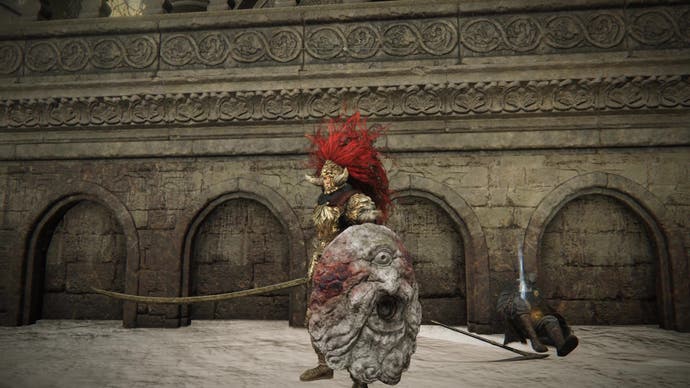 A warrior stands next to Ansbach's body in Elden Ring Shadow of the Erdtree.