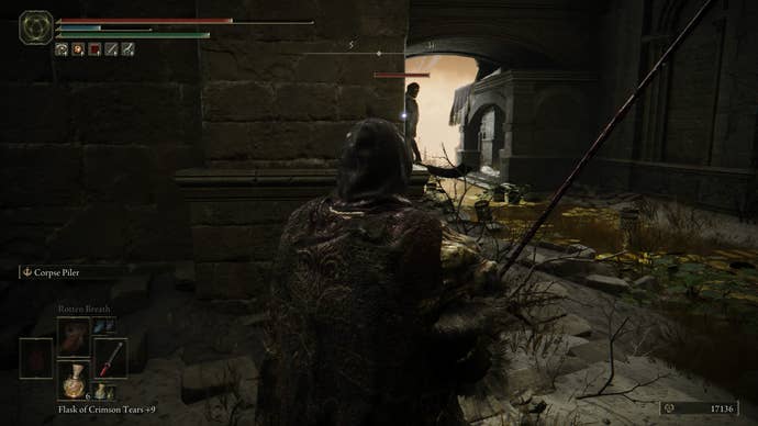 The Tarnished targeting a large shadow warrior hiding around a corner in Belurat in Elden Ring Shadow of the Erdtree.