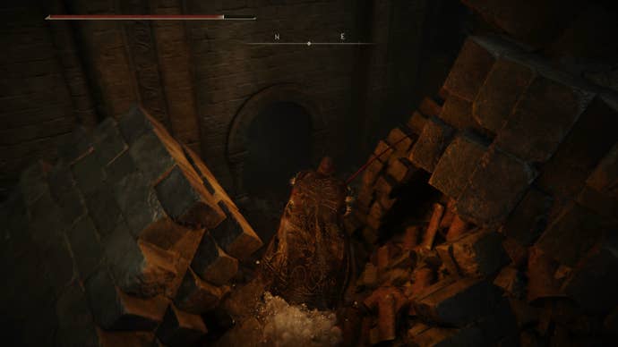 The Tarnished dropping down to a hidden door in Belurat in Elden Ring Shadow of the Erdtree.