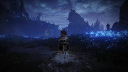 A warrior rides through a field of luminous blue flowers in the Cerulean Coast region of Elden Ring Shadow of the Erdtree on the way to the Finger Ruins of Rhia.