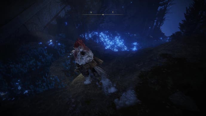A warrior rides down a slope of blue flower on the way to the Finger Ruins of Rhia in Elden Ring Shadow of the Erdtree.