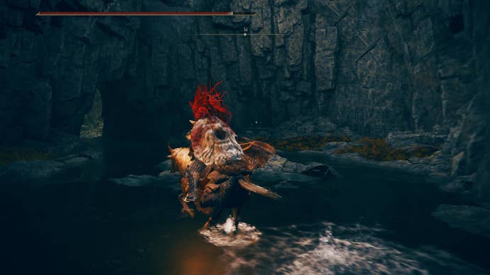 A warrior rides a horse towards a Revered Spirit Ash statue in the Ellac River Cave in Elden Ring Shadow of the Erdtree.