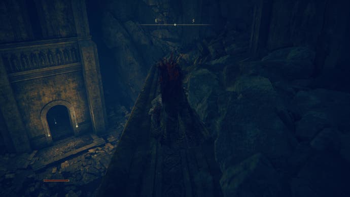 A warrior stands on a dark platform down a large hole  as they travel toward the east side of the Shadow Keep in Elden Ring Shadow of the Erdtree.