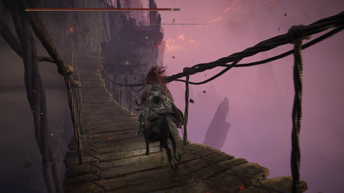 A warrior rides their horse across a wooden bridge against a sky of red lightning on the way to meet Igon on Jagged Peak in Elden Ring Shadow of the Erdtree.