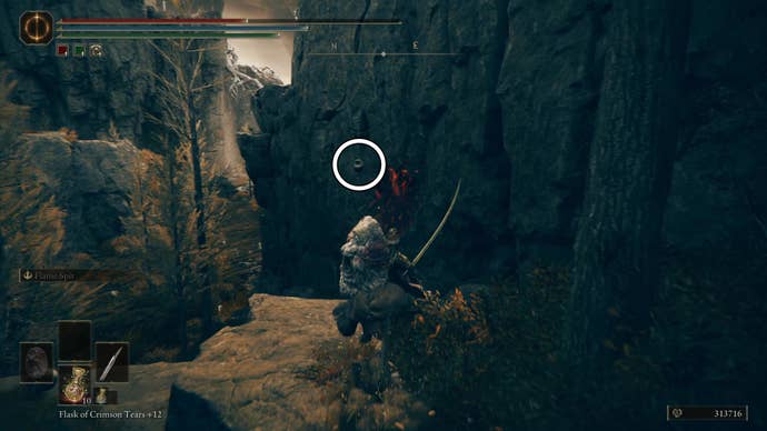 A warrior rides toward the edge of a cliff where an urn holding the String Seller’s Bell Bearing is strung up on the wall, highlighted by a white circle, in Elden Ring Shadow of the Erdtree.
