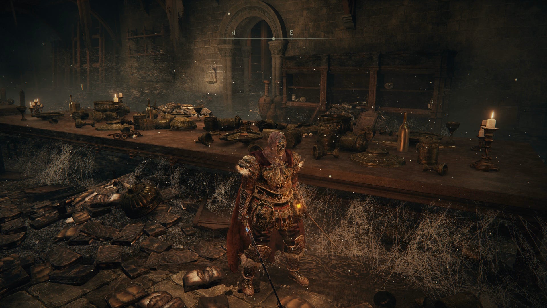 The Tarnished standing next to a dining table in Midra's Manse in Elden Ring Shadow of the Erdtree. - 5