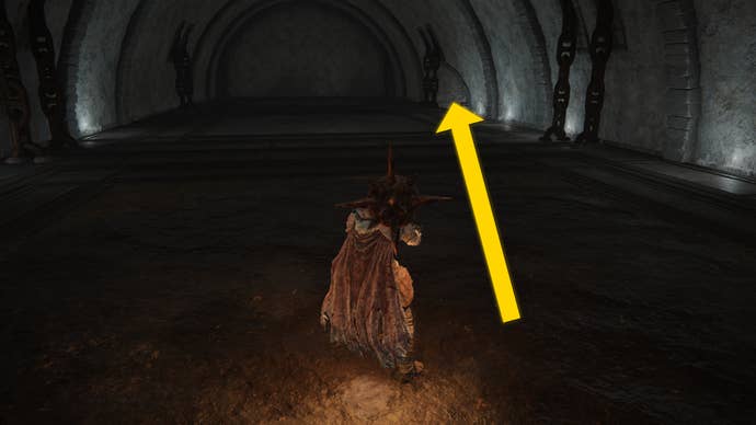 The player in Elden Ring: Shadow Of The Erdtree makes their way through the Fog Rift Catacombs, with a yellow arrow pointing towards the location of the hidden Altar.