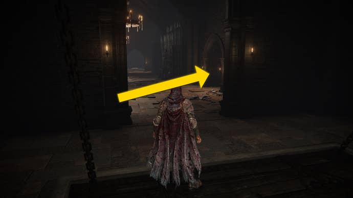 The player in Elden Ring: Shadow Of The Erdtree stands at the bottom of an elevator shaft. A yellow arrows points to a doorway on the right-hand side.