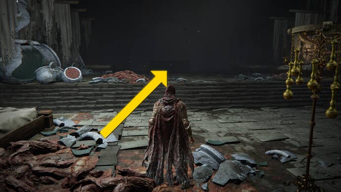 The player in Elden Ring: Shadow Of The Erdtree approaches an altar in a hall beneath the Shadow Keep. A yellow arrow points towards the altar.