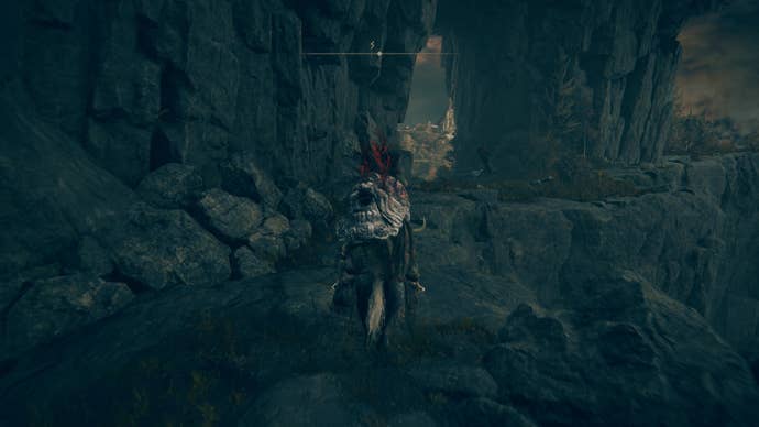 A warrior rides their horse down a cliff path to Prospect Town in Gravesite Plain in Elden Ring Shadow of the Erdtree.