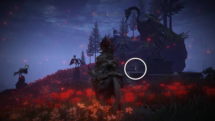 A warrior rides their horse through a red flower field in front of a large bird statue at night, where a white circle highlights the location of the Rings of Spectral Light Sorcery spell in Elden Ring Shadow of the Erdtree.
