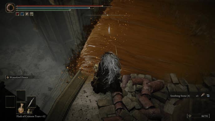 A warrior looks down at a hidden item in a brown waterfall in Belurat, Tower Settlement in Shadow of the Erdtree