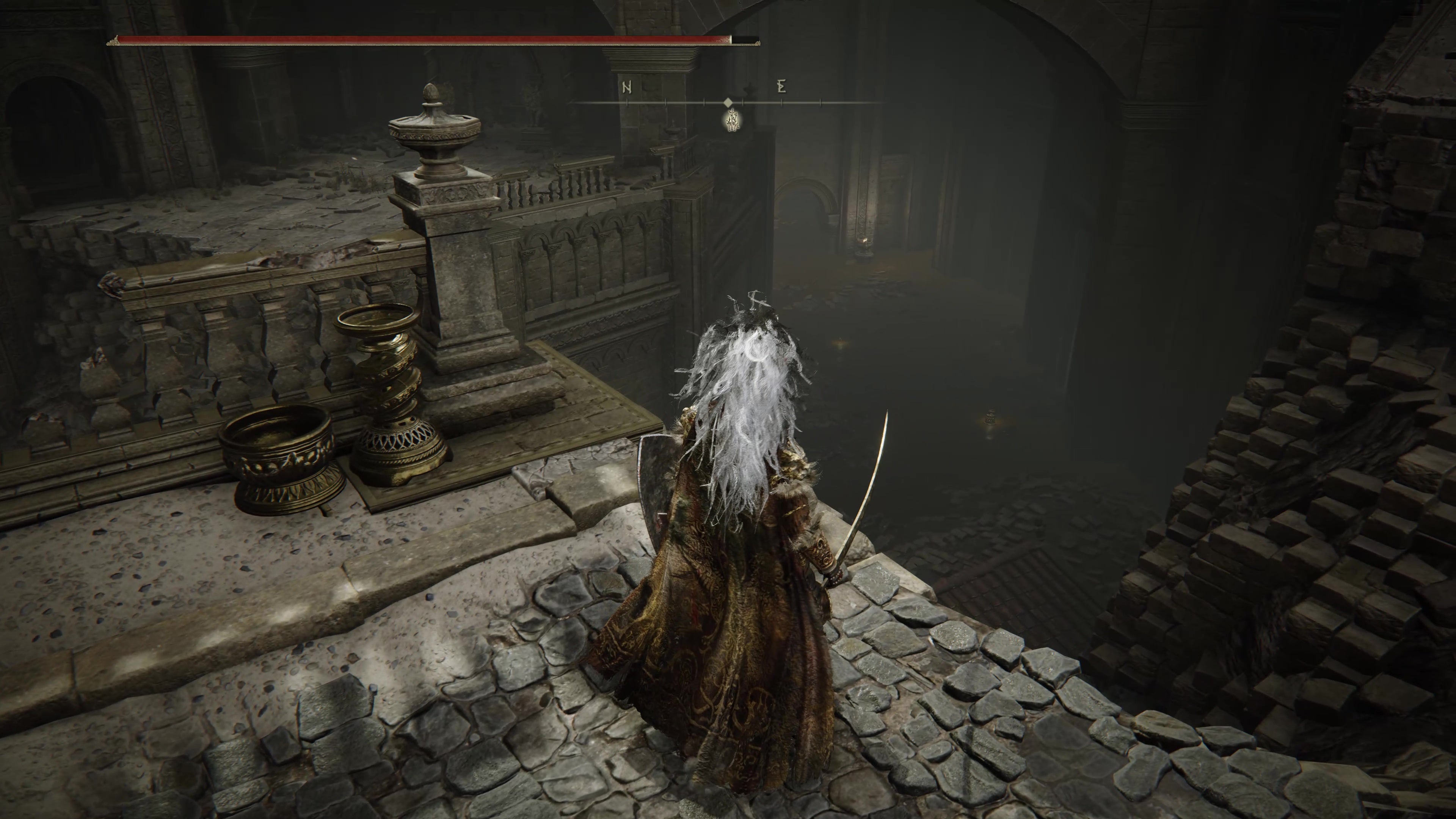 A warrior looks down on a lower passageway in Belurat, Tower Settlement in Shadow of the Erdtree