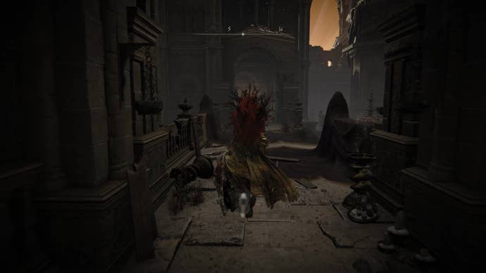 A warrior runs down a dark corridor in Belurat, Tower Settlement in Shadow of the Erdtree