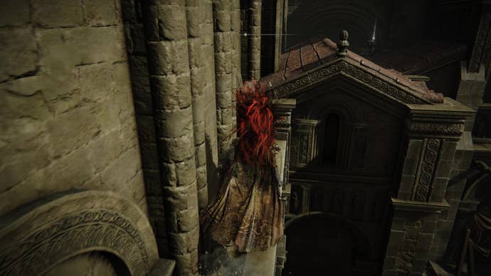 A warrior hops over a narrow wall to reach a corpse in Belurat, Tower Settlement in Shadow of the Erdtree.