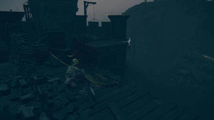 A warrior runs towards a hanging corpse in the Fort of Reprimand in Shadow of the Erdtree.