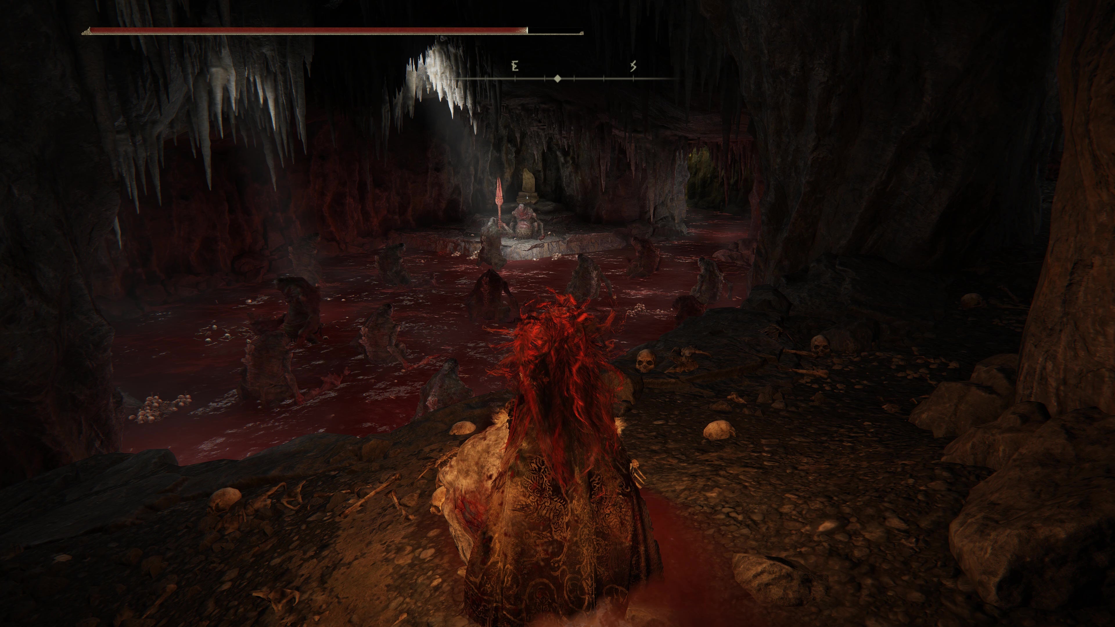 A warrior looks on a strange scene inside  the Rivermouth Cave in Shadow of the Erdtree, where trolls worship a stone altar on a pool of blood.