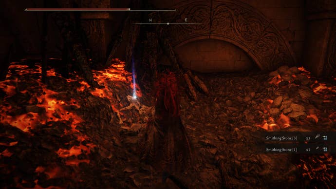 A warrior approaches a shining corpse inside the Ruined Forge Lava Intake dungeon in Shadow of the Erdtree.