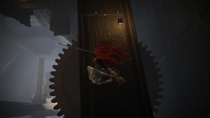 A warrior drops down onto a large cog in the Storehouse tower on the way to the Shadow Keep's Back Gate in Elden Ring Shadow of the Erdtree.