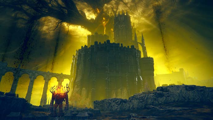 An establishing shot of the Shadow Keep in Elden Ring: Shadow Of The Erdtree, against a dark and golden sky with the Shadow Tree in the background and a Furnace Golem in the foreground to the side.